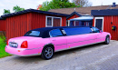 Umea, Sweden - September 15, 2019: A Pink Limo Stands On the Driveway With A Red House In the Background