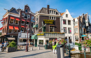 Amsterdam, Netherlands - June 22, 2019: Buildings In the Old Town of Amsterdam. People Enjoying the Sunny Weather