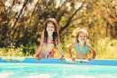 101606892-children-swim-in-the-pool-in-garden