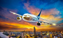 Avião voando sobre uma cidade ao pôr do sol